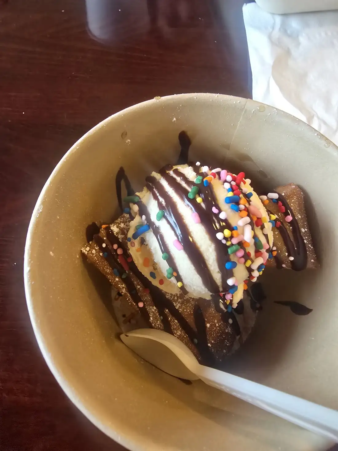 A Ganotisi’s dessert with ice cream, chocolate drizzle and sprinkles